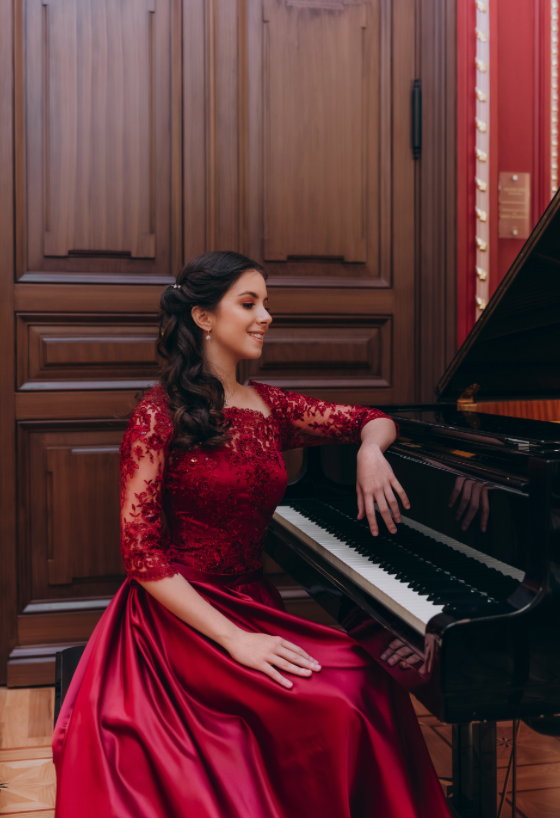 In a red gown at the keyboard