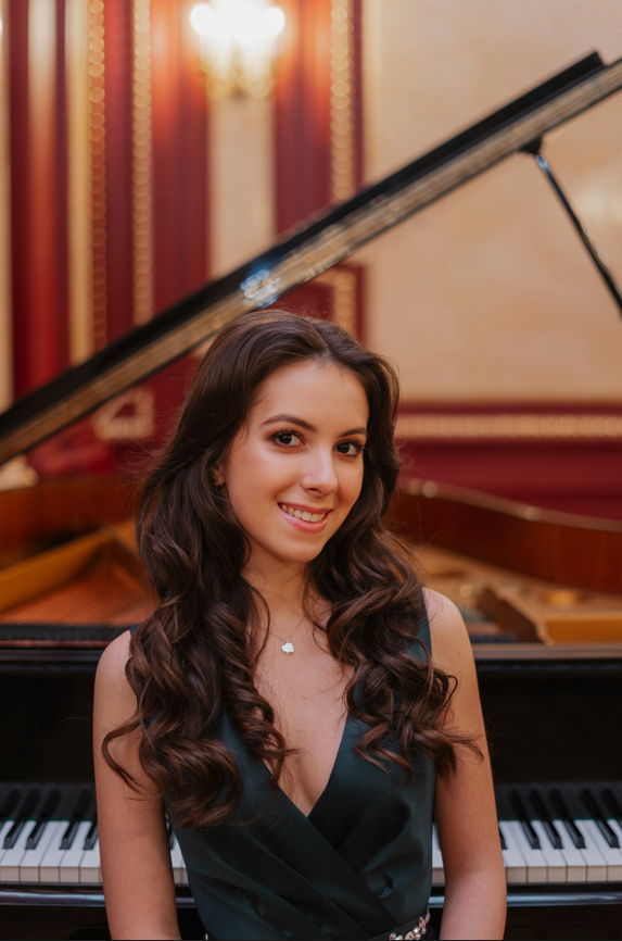 Henrietta smiling at the grand piano